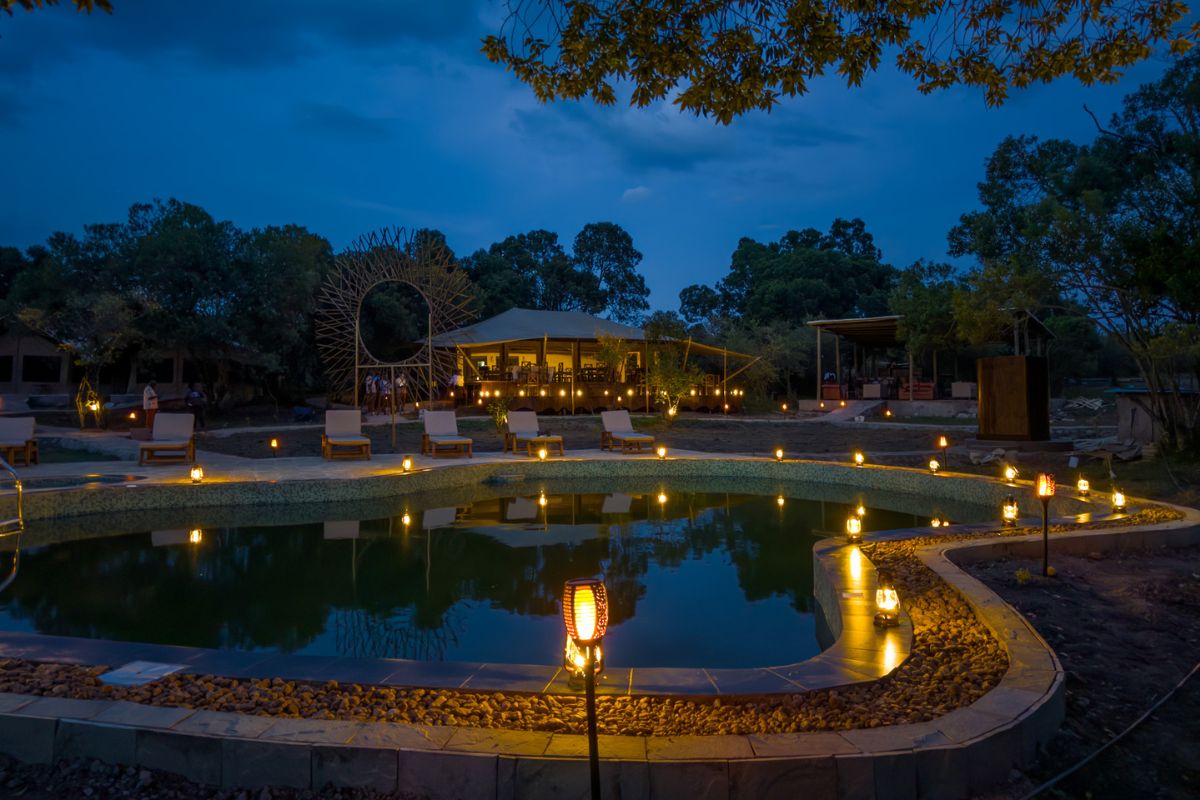 Illuminated pool area at Ilora Retreats luxury camp in the Masai Mara Kenya at night