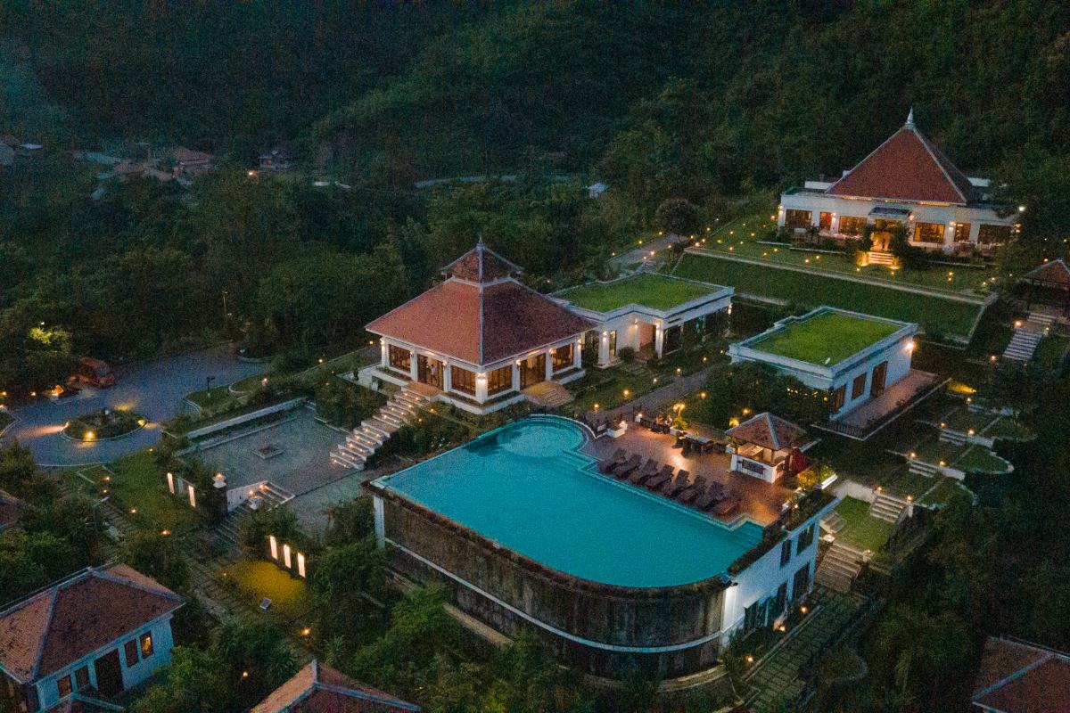 Aerial view of Le Grand Pakbeng resort with infinity pool and villas in the jungle of Pak Beng Laos